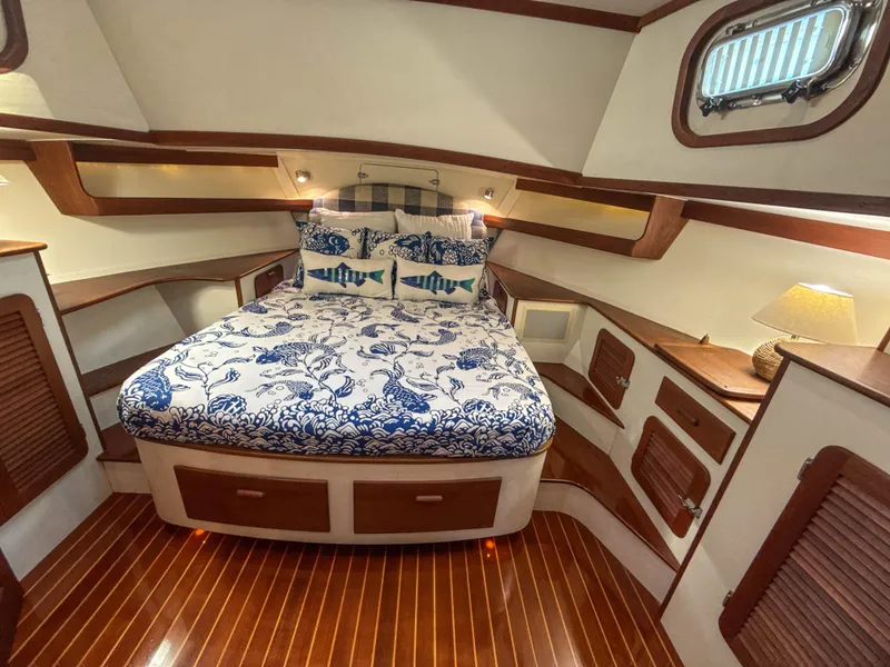 Slide: The Image of Luxurious 2000 Cherubini Independence yacht cabin with nautical-themed bedding and elegant wood finishes. - 43