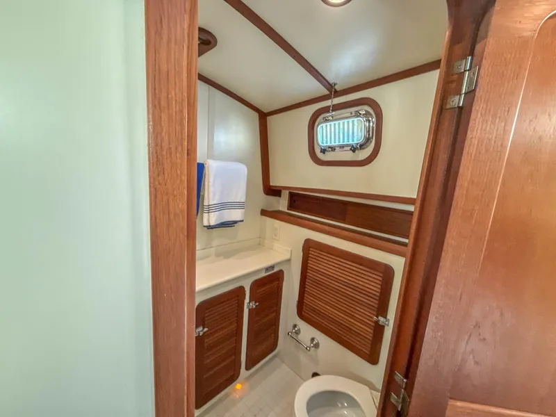 Slide: The Image of 2000 Cherubini Independence yacht bathroom with wood accents and compact design. - 49