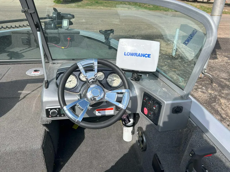 Slide: The Image of 2013 Lowe 185 Pro Series boat dashboard with steering wheel and Lowrance navigation system. - 6