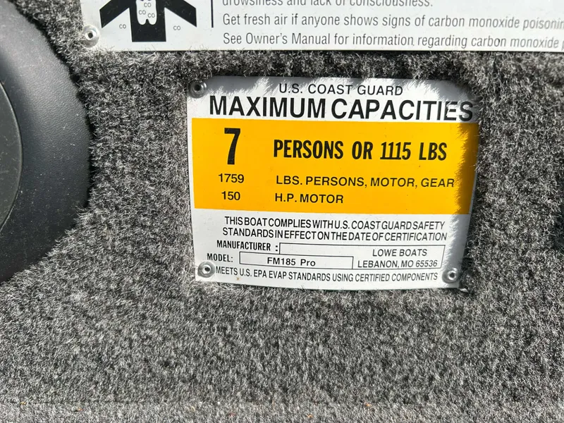 Slide: The Image of U.S. Coast Guard capacity label for 2013 Lowe 185 Pro Series boat, 7 persons or 1115 lbs. - 7