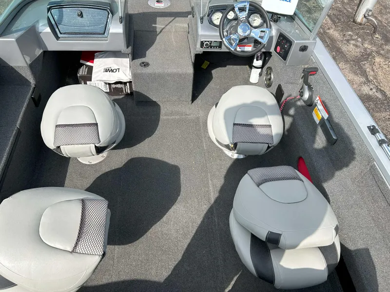 Slide: The Image of 2013 Lowe 185 Pro Series boat interior with four seats and steering console. - 8