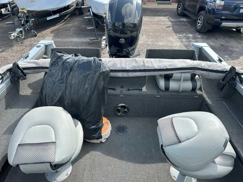 Slide: The Image of 2013 Lowe 185 Pro Series boat interior with seating and motor. - 9