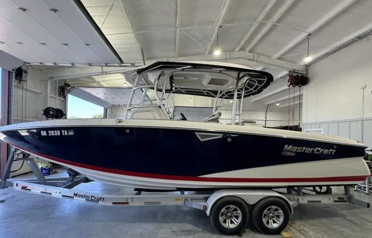 Slide: The Image of 2009 MasterCraft CSX 265 SS boat on trailer in indoor storage facility. - 1