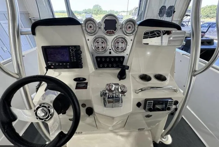 Slide: The Image of 2009 MasterCraft CSX 265 SS boat dashboard with steering wheel, gauges, and controls. - 12
