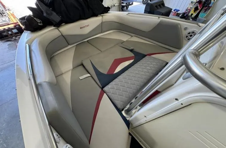 Slide: The Image of 2009 MasterCraft CSX 265 SS boat interior with cushioned seating and sleek design. - 16