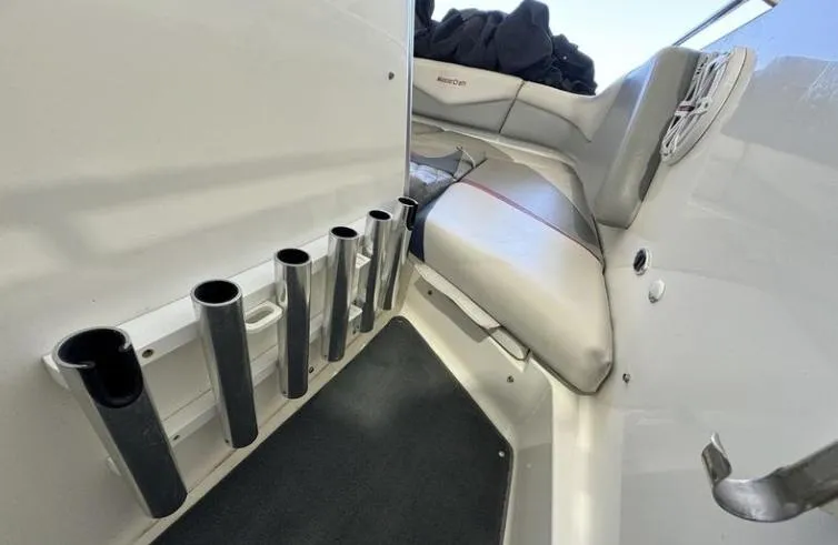 Slide: The Image of 2009 MasterCraft CSX 265 SS interior with rod holders and cushioned seating. - 18
