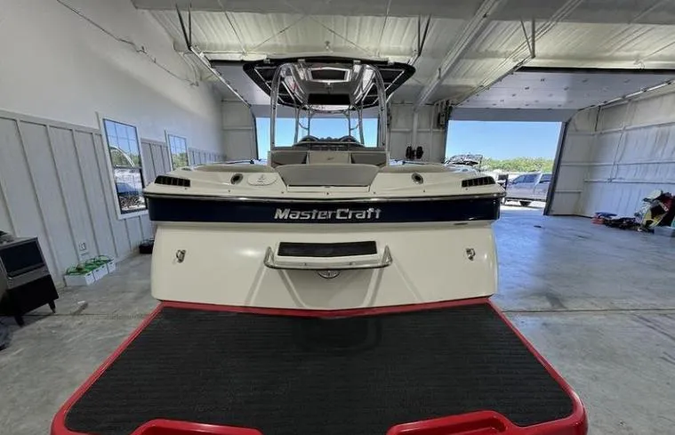 Slide: The Image of 2009 MasterCraft CSX 265 SS boat in a garage, rear view. - 2