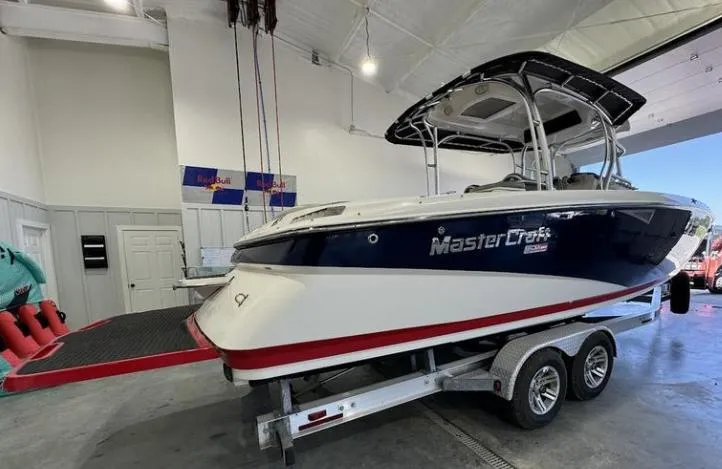 Slide: The Image of 2009 MasterCraft CSX 265 SS boat on trailer in indoor storage facility. - 4