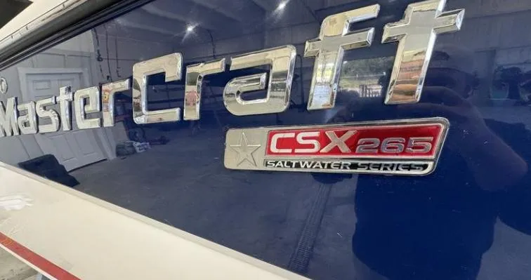 Slide: The Image of 2009 MasterCraft CSX 265 SS boat logo in a garage setting. - 5