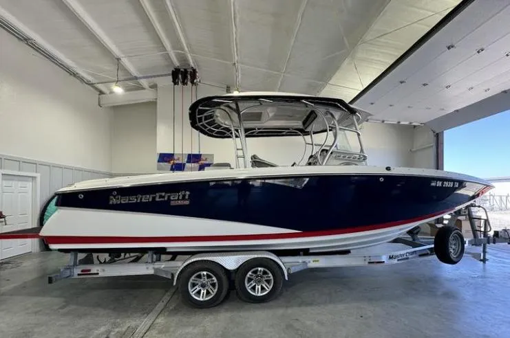 Slide: The Image of 2009 MasterCraft CSX 265 SS boat on trailer in indoor storage facility. - 6