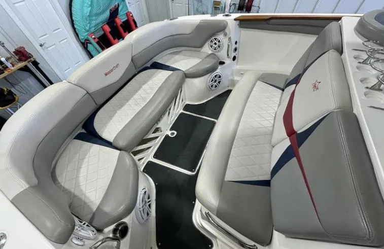 Slide: The Image of 2009 MasterCraft CSX 265 SS boat interior with gray and white seating, featuring diamond stitching. - 8