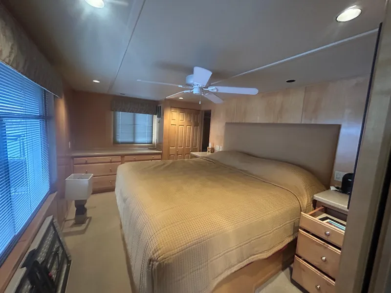 Slide: The Image of Luxurious bedroom in 2006 American Waterways houseboat, featuring a large bed and wooden furnishings. - 14