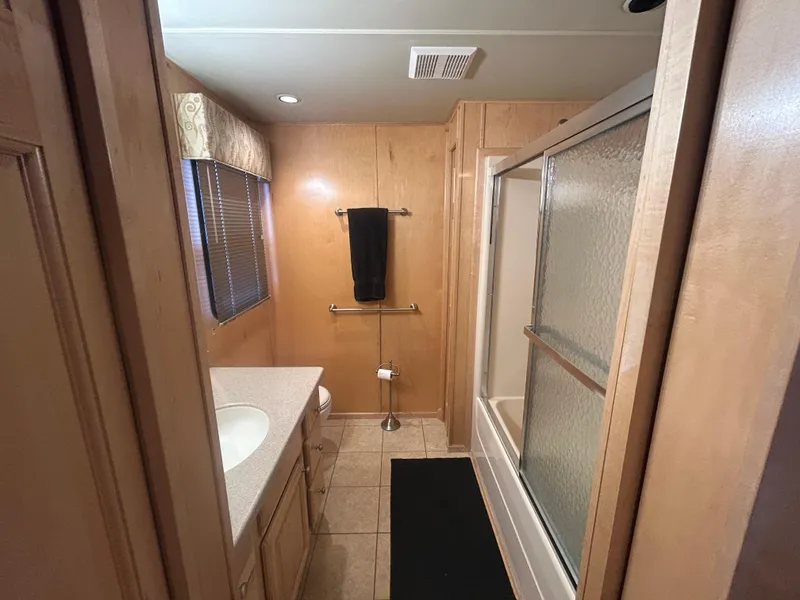 Slide: The Image of Bathroom interior of 2006 American Waterways Sweet Escape, featuring shower and vanity. - 15