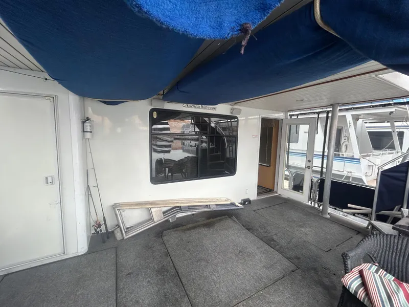 Slide: The Image of Houseboat deck with blue canopy, 2006 American Waterways Sweet Escape model, docked at marina. - 16