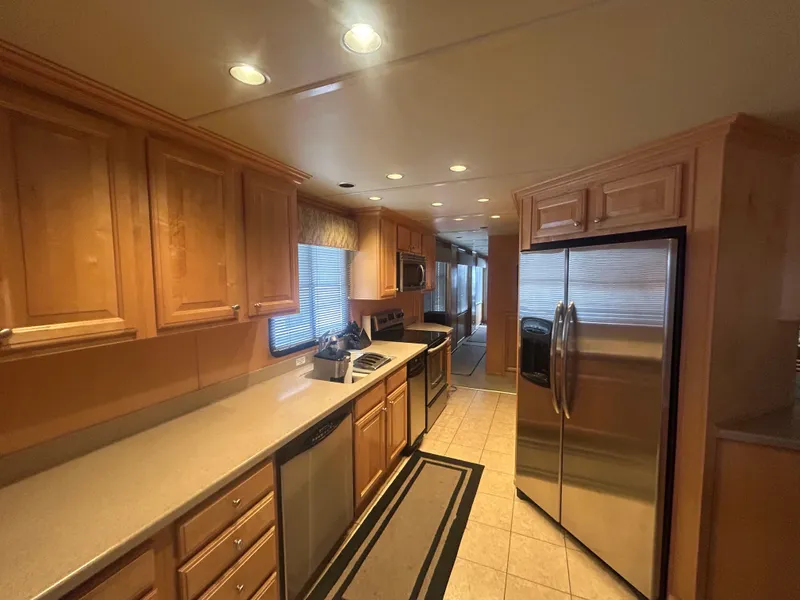Slide: The Image of Spacious kitchen in 2006 American Waterways Sweet Escape houseboat with modern appliances and wooden cabinetry. - 9