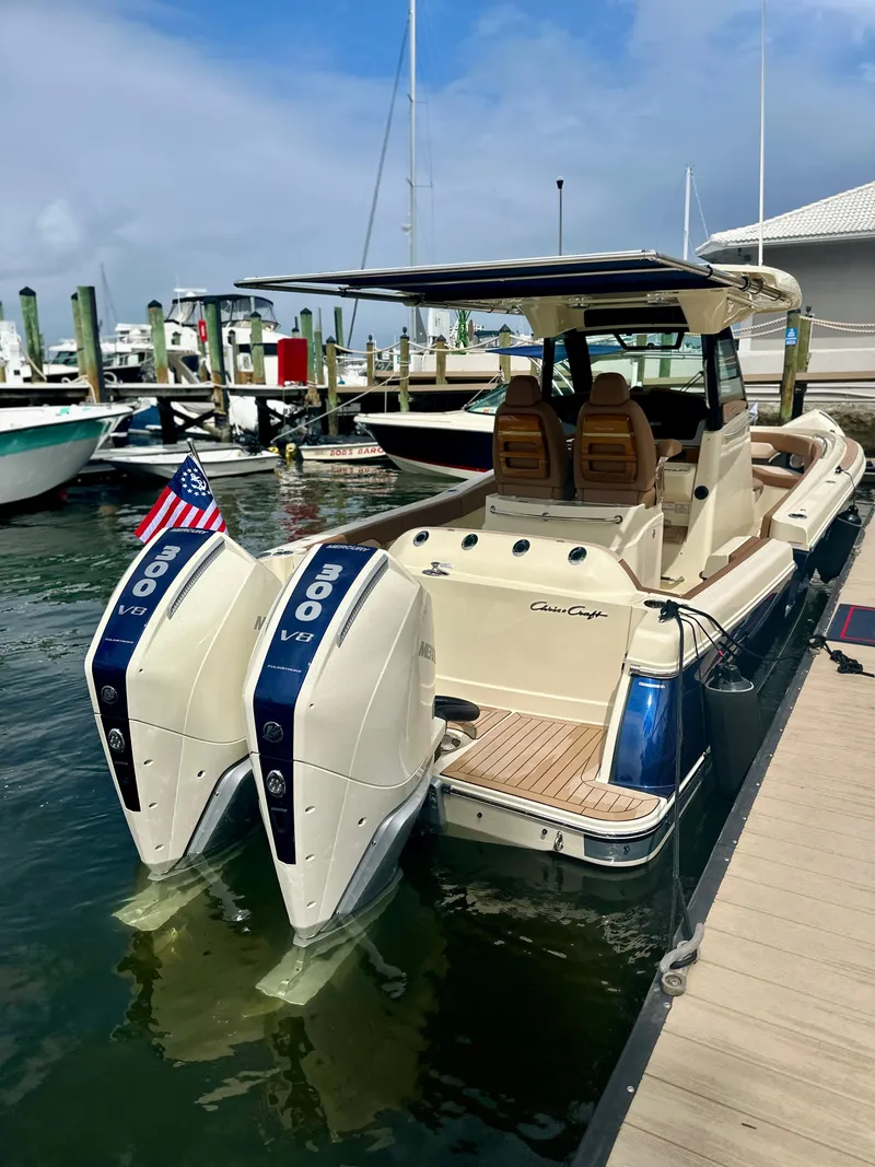 Slide: The Image of 2025 Chris-Craft Catalina boat docked with twin outboard engines and American flag. - 6