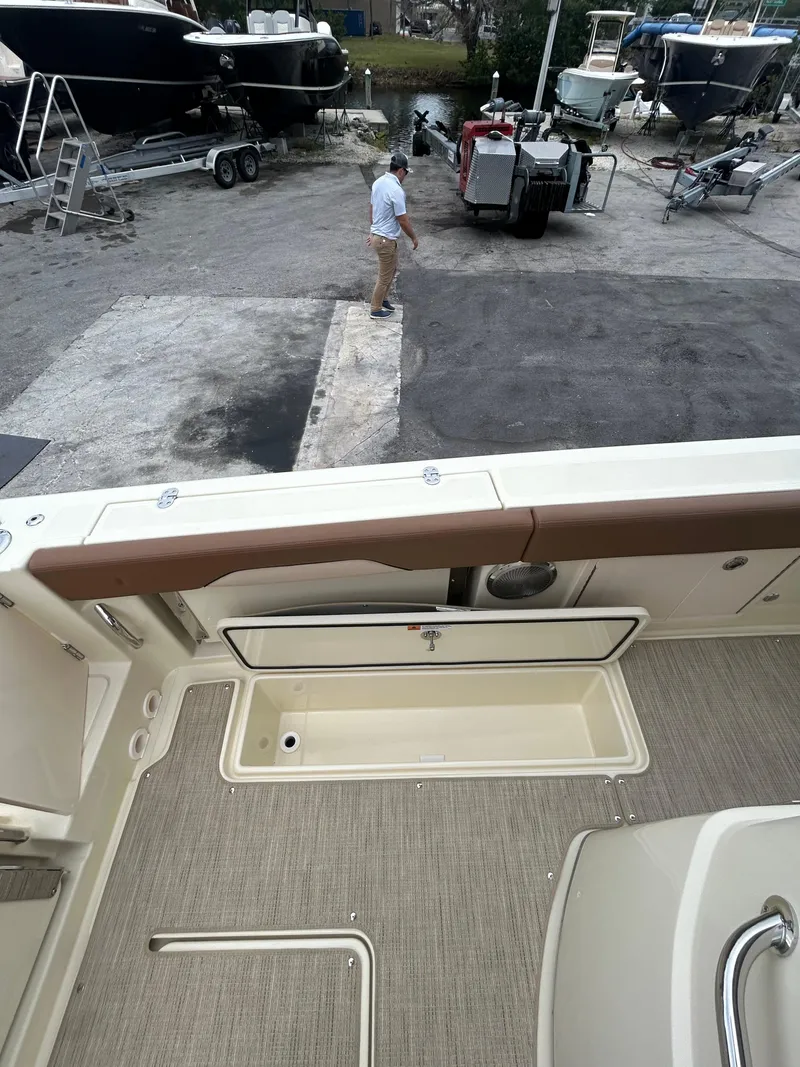 Slide: The Image of 2025 Chris-Craft 31 Catalina boat interior, docked with other boats in the background. - 10