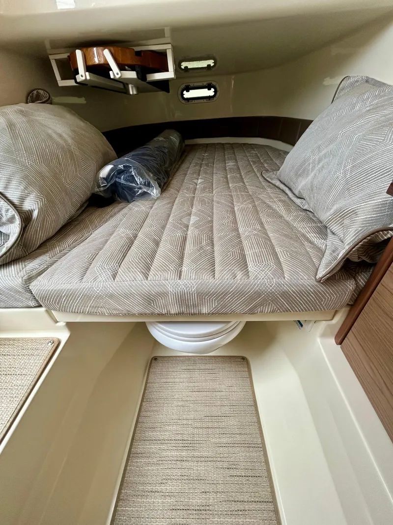Slide: The Image of 2025 Chris-Craft 31 Catalina cabin interior with cushioned bed and modern design. - 13