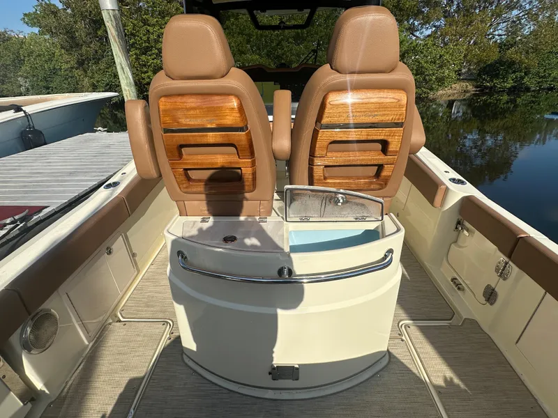 Slide: The Image of 2025 Chris-Craft Catalina boat interior with tan seats and wooden accents. - 2