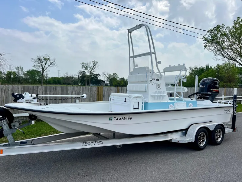 Slide: The Image of 2017 Shallow Sport 24 Sport boat on trailer, parked outdoors under cloudy sky. - 1
