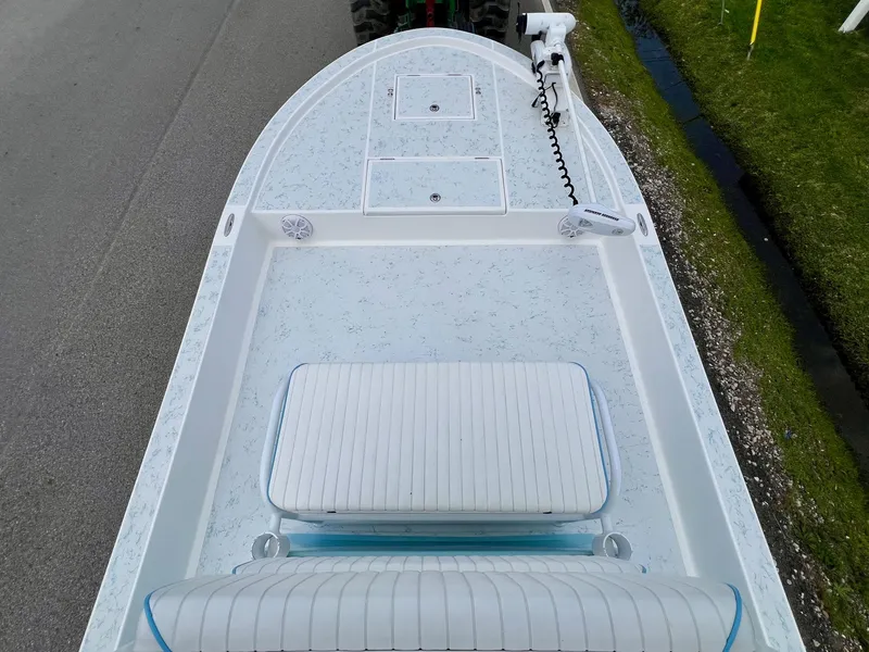 Slide: The Image of 2017 Shallow Sport 24 Sport boat deck with seating and storage compartments. - 13