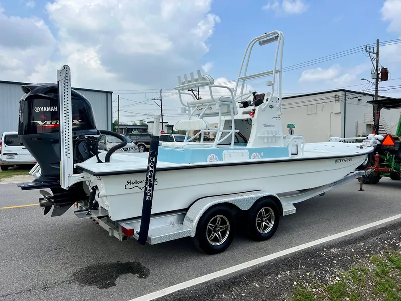 Slide: The Image of 2017 Shallow Sport 24 Sport boat on trailer with Yamaha outboard motor, parked on street. - 4