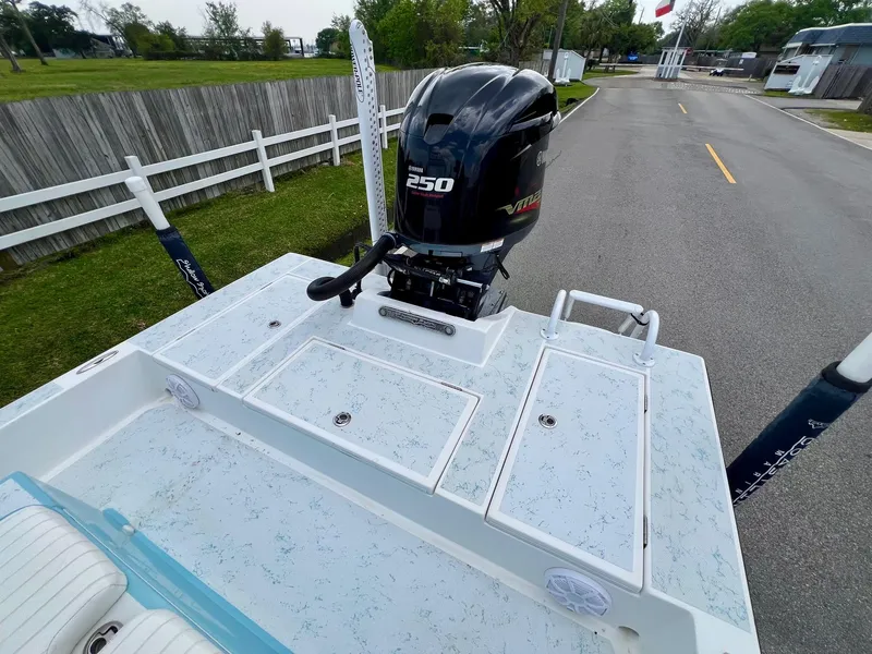 Slide: The Image of 2017 Shallow Sport 24 Sport boat with powerful 250 engine, parked on a paved road. - 7