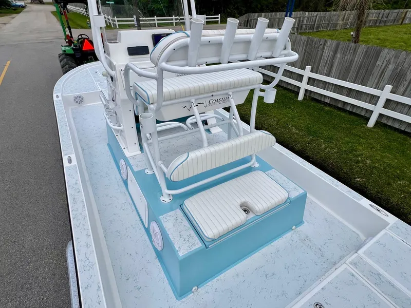 Slide: The Image of 2017 Shallow Sport 24 Sport boat with white seating and light blue accents. - 8