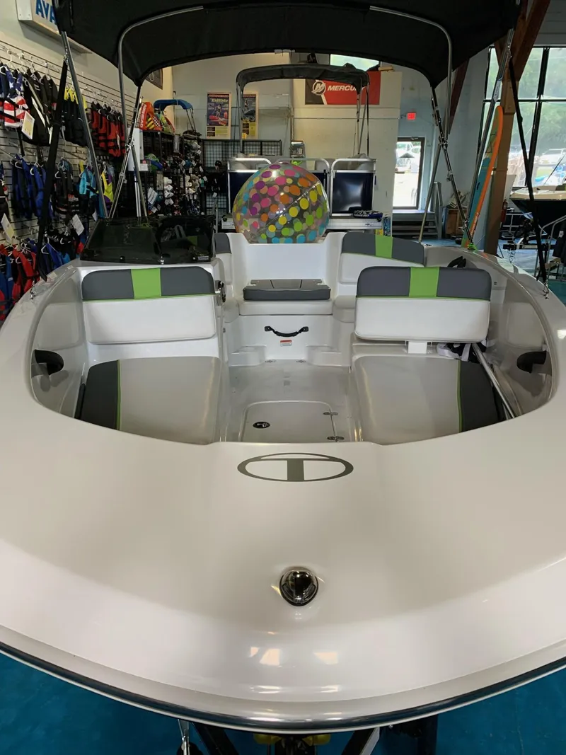Slide: The Image of 2024 Tahoe T16 boat interior with seating, displayed in a showroom. - 2