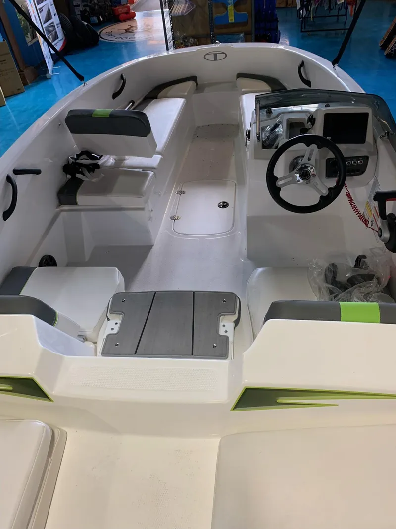 Slide: The Image of 2024 Tahoe T16 boat interior with steering wheel, seating, and control panel. - 37