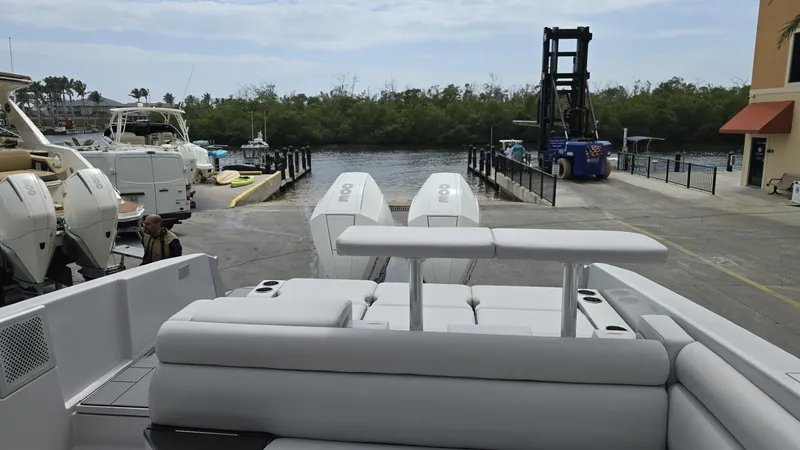 Slide: The Image of 2020 Aviara AV32 OB boat with dual outboard engines at a marina dock. - 11