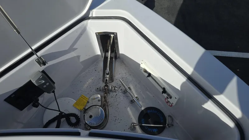 Slide: The Image of Bow anchor compartment of 2020 Aviara AV32 OB boat, featuring anchor and winch system. - 15
