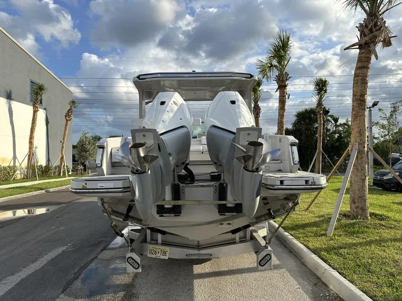 Slide: The Image of 2020 Aviara AV32 OB boat with dual outboard engines, parked on a sunny day. - 19