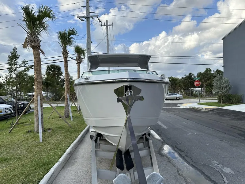 Slide: The Image of 2020 Aviara AV32 OB boat on trailer, parked near palm trees and street. - 4