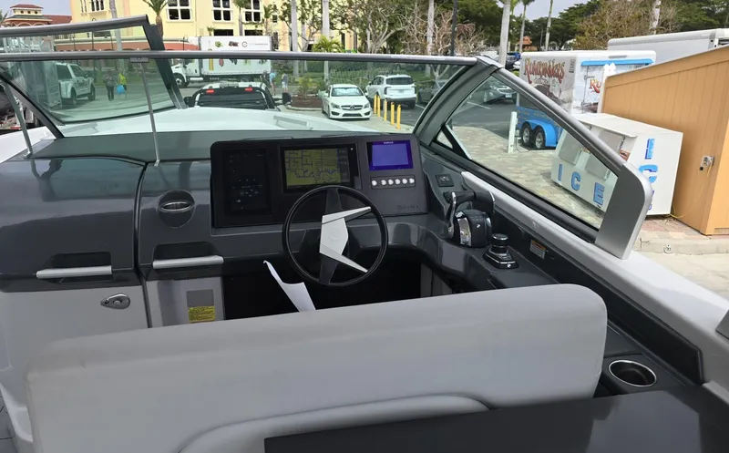 Slide: The Image of 2020 Aviara AV32 OB boat cockpit with modern controls and steering wheel. - 7
