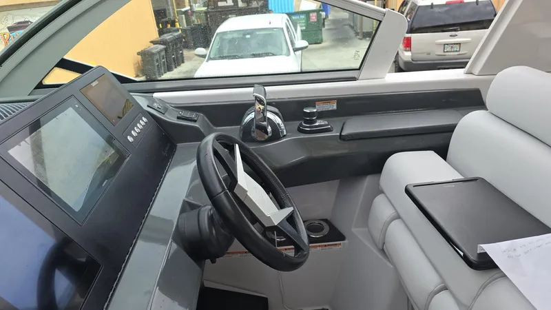 Slide: The Image of 2020 Aviara AV32 OB boat cockpit with modern steering and control panel. - 9