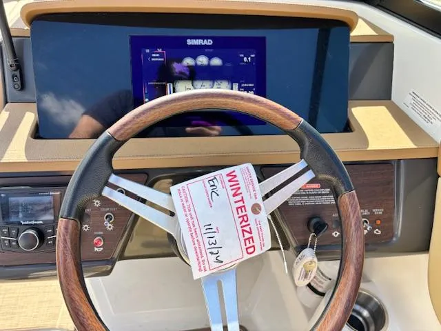 Slide: The Image of Steering wheel of 2018 Sea Ray SPX 210 boat with winterized tag and Simrad display. - 12
