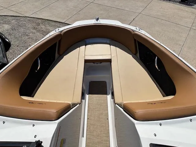 Slide: The Image of 2018 Sea Ray SPX 210 boat interior with tan seating and spacious layout. - 14