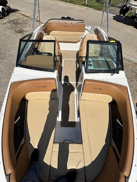 Slide: The Image of 2018 Sea Ray SPX 210 boat with tan interior and open deck layout. - 15