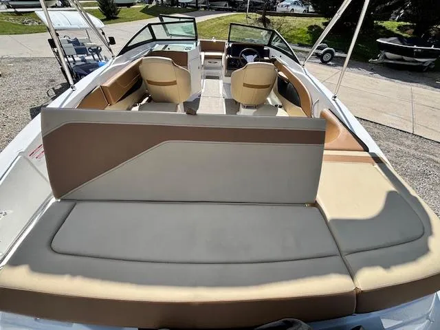 Slide: The Image of 2018 Sea Ray SPX 210 boat interior with beige seating and open deck layout. - 3