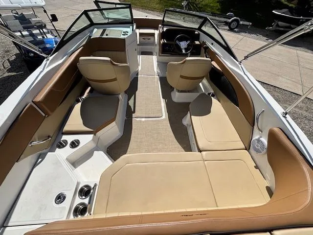 Slide: The Image of 2018 Sea Ray SPX 210 boat interior with tan seating and modern dashboard. - 4
