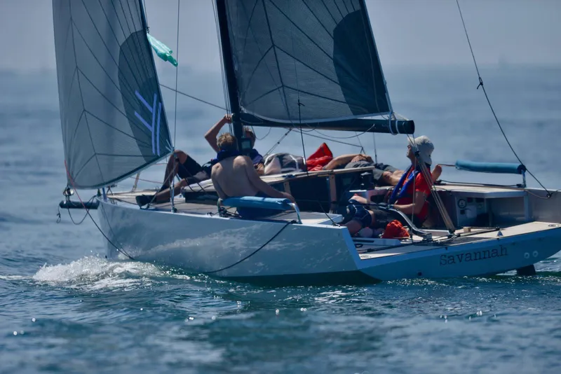 Slide: The Image of Sailboat "Savannah" on water, Black Pepper Code# 2025 model, with crew enjoying a sunny day. - 4