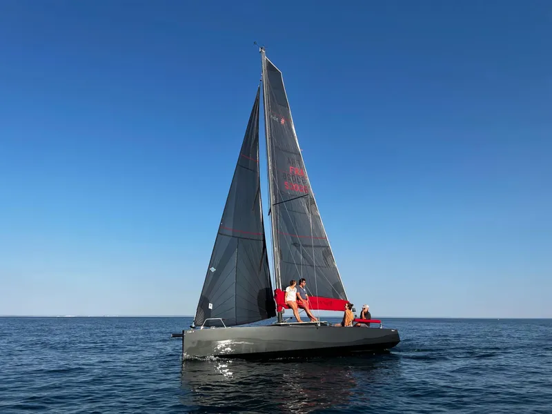 Slide: The Image of Sleek Black Pepper Code# sailboat on open sea, 2025 model, under clear blue sky. - 5