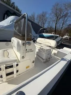 Slide: The Image of 2009 Key West 1720 Center Console boat with white seating and console, parked outdoors. - 3