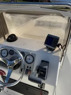 Slide: The Image of 2009 Key West 1720 Center Console boat dashboard with steering wheel and navigation instruments. - 6