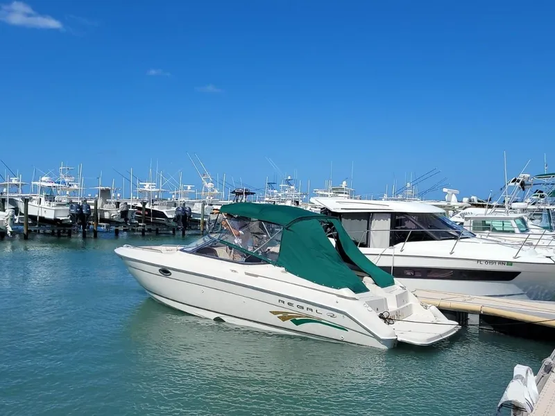 Slide: The Image of 2000 Regal 2800 LSR boat docked in a marina with clear blue skies. - 0