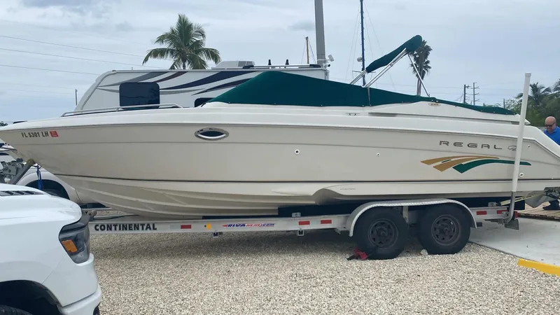 Slide: The Image of 2000 Regal 2800 LSR boat on trailer, parked outdoors. - 1