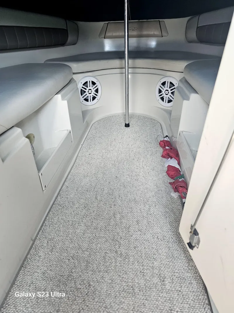 Slide: The Image of Interior of a 2000 Regal 2800 LSR boat with seating and speakers. - 10