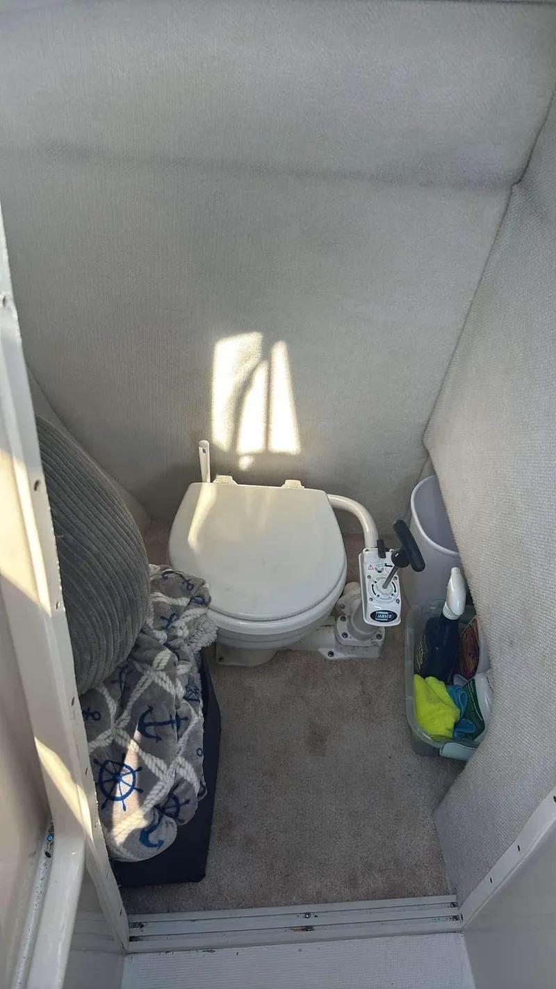 Slide: The Image of 2000 Regal 2800 LSR boat bathroom with toilet and storage area. - 13