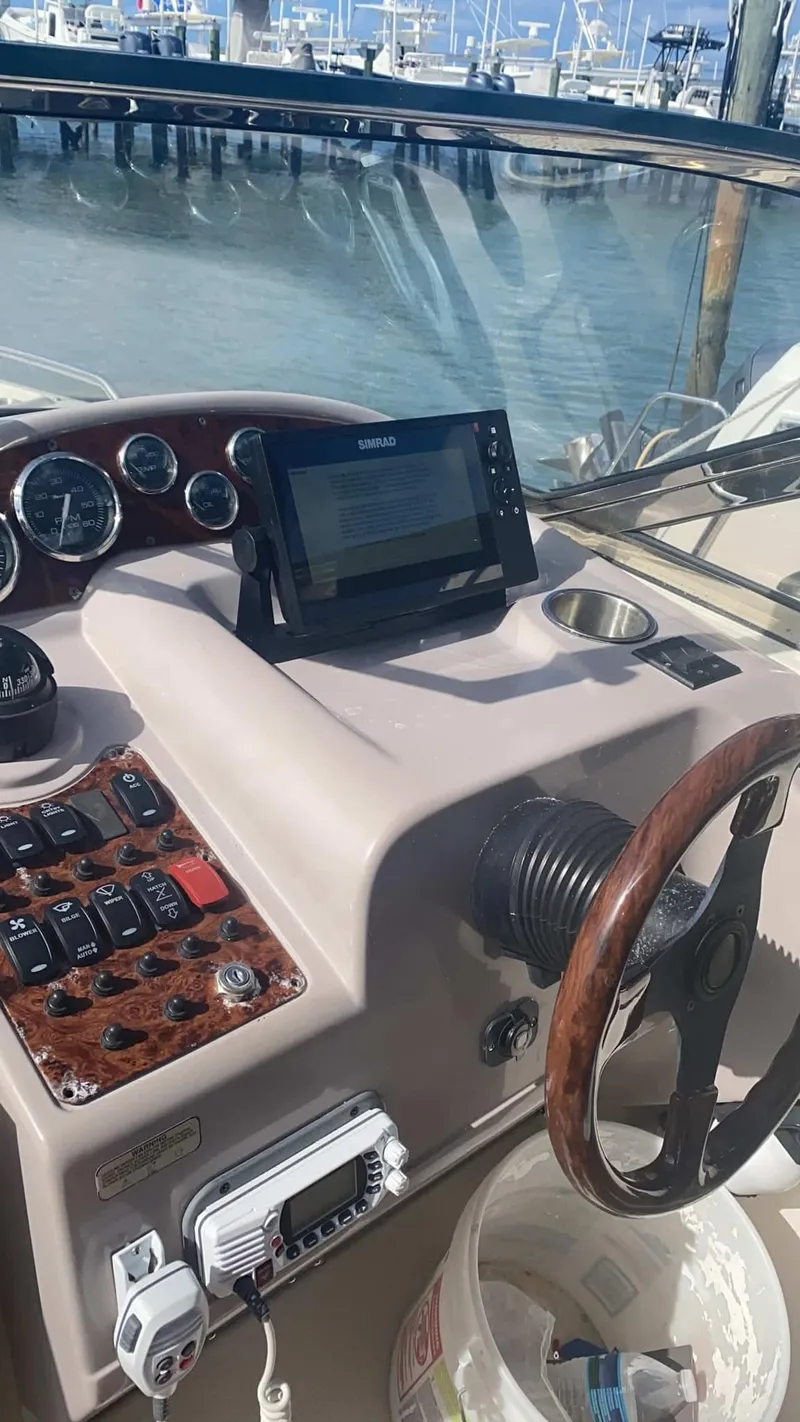 Slide: The Image of 2000 Regal 2800 LSR boat dashboard with steering wheel and navigation equipment. - 15
